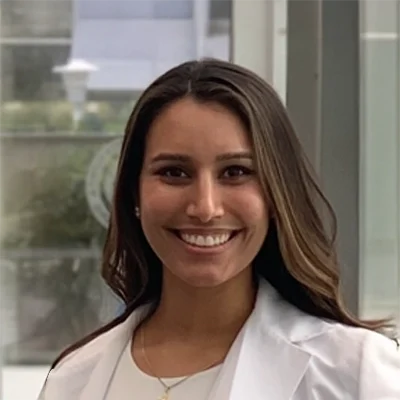 Kayla Drapala smiling in a white shirt.